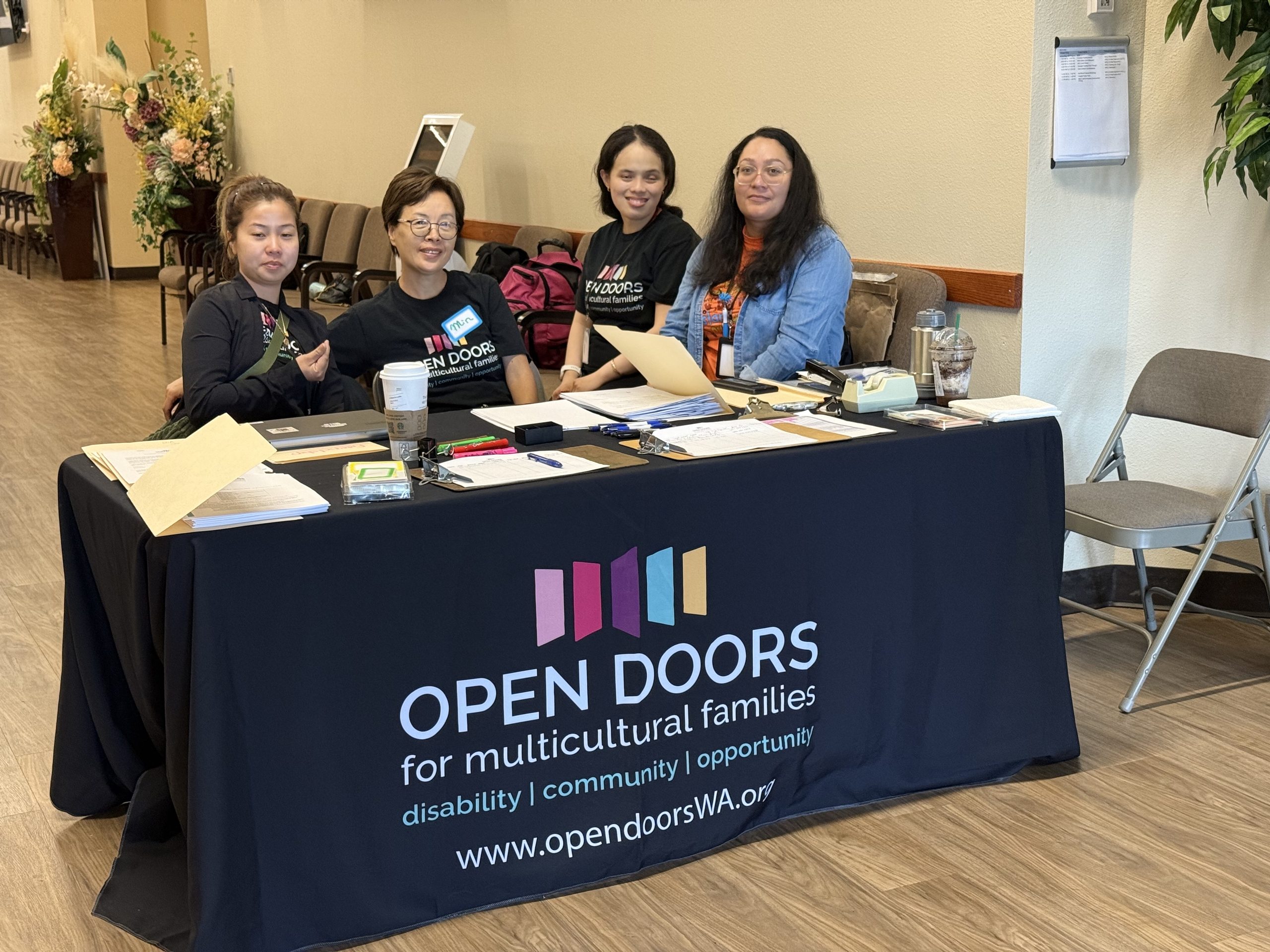 May contain four people at a table with "Open Doors" logo.